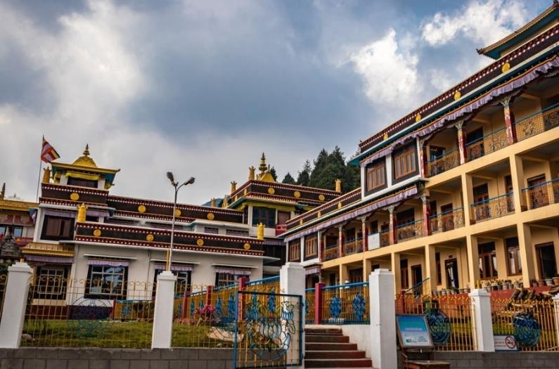Ancient buddhist colorful monastery with cloudy sky.
