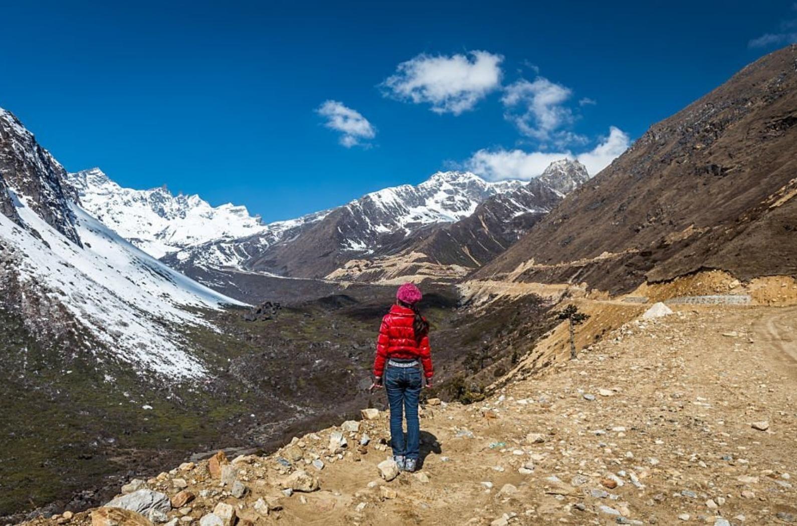 Woman stands near Chopta Valley, Lachen, Sikkim.