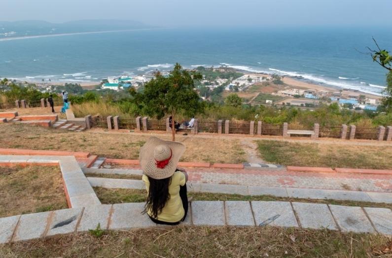 A lonely woman sitting on the top of Thotlakonda View Point and enjoying the view at Visakhapatnam.