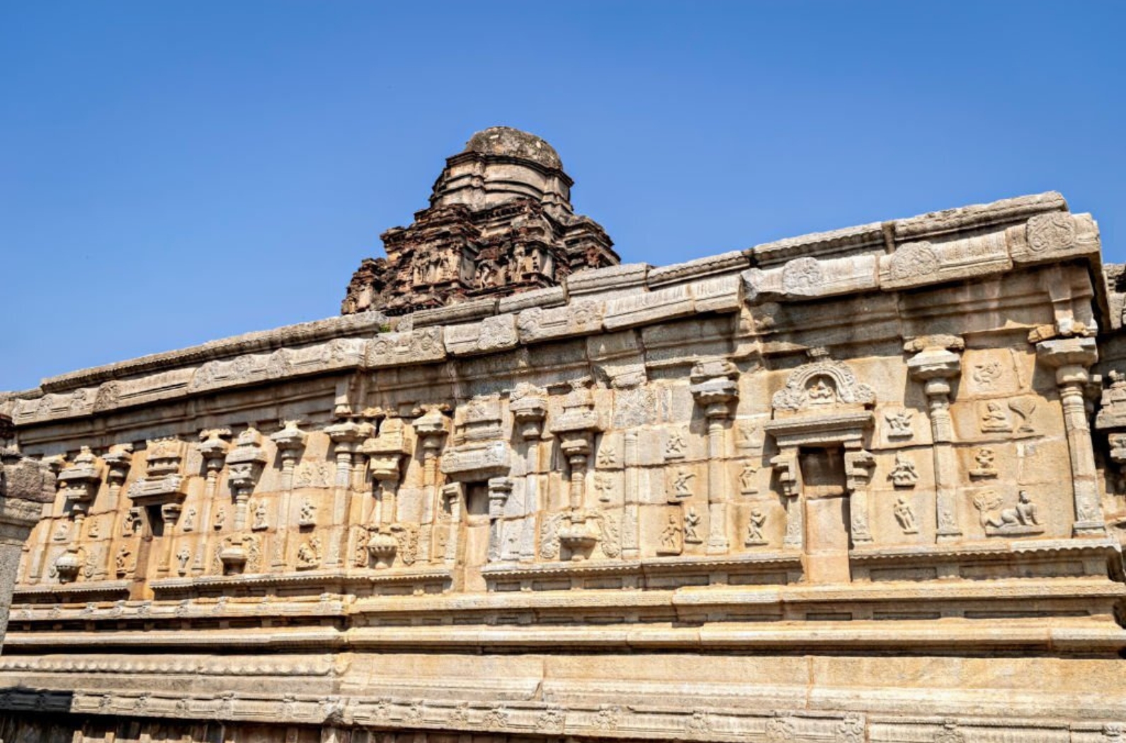 Carvings on the wall of ancient Vijaya Vitthala temple in Hampi, Karnataka, India.