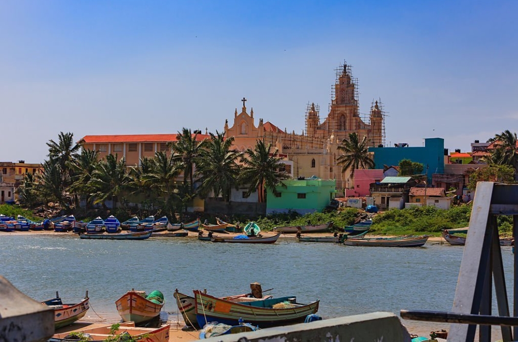 Many fishing boats moored or beached on the creekside, appear deserted in the afternoon sunlight.