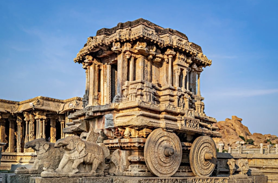 Richly sculpted stone chariot with clear blue sky background at Hampi, Karnataka. It is considered to be the most stunning architecture of the Vijayanagara kingdom.