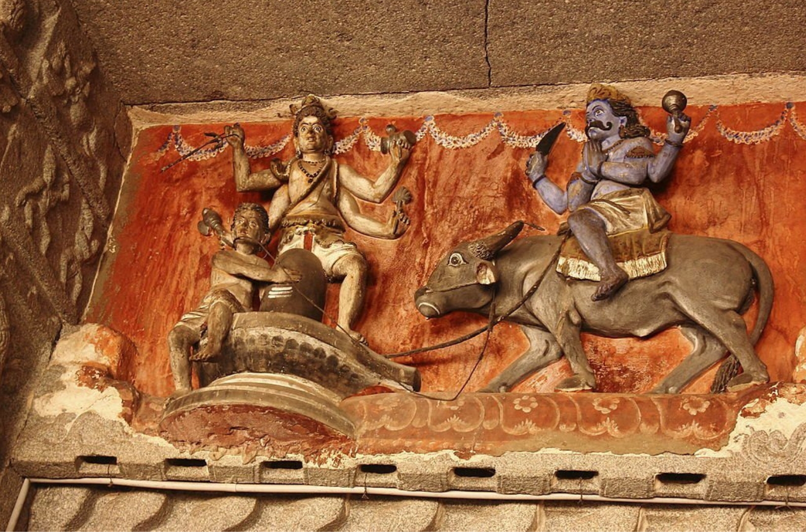 Stone carved ancient sculpture of hindu God Shiva and others in Virupaksha temple in Hampi, Karnataka, India.