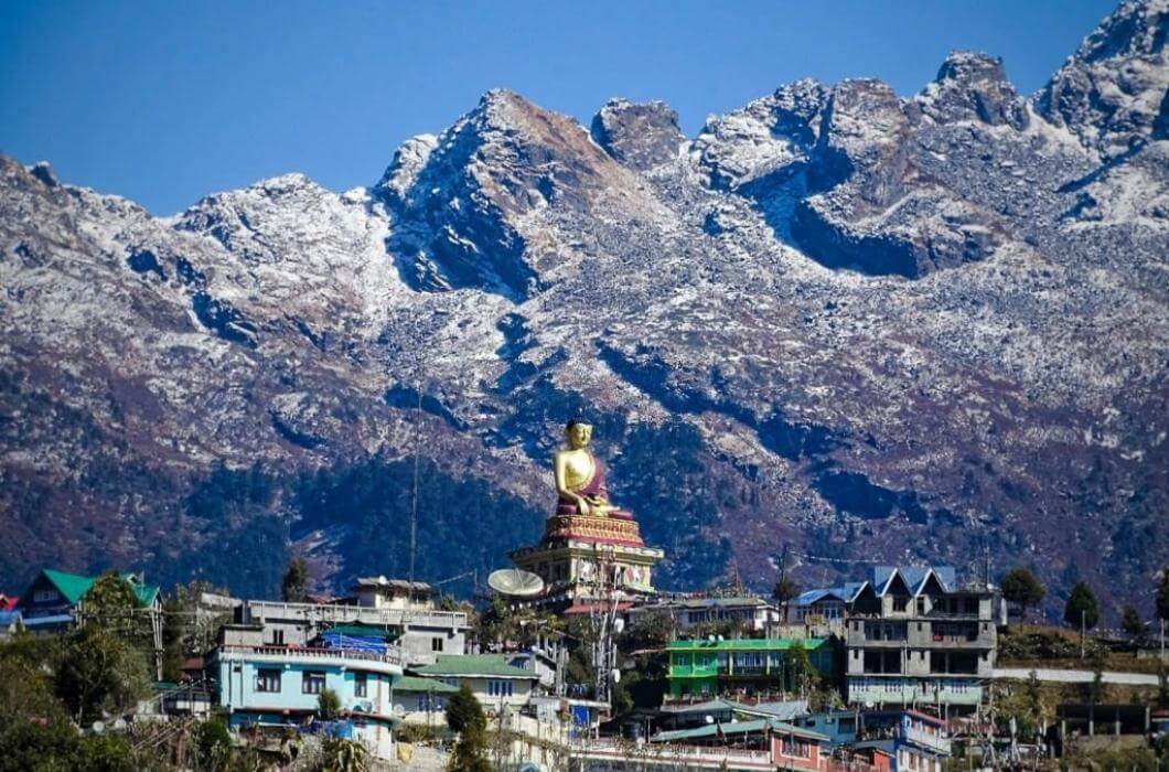 Gaint buddha statue of tawang surrounded by mighty Himalayan Mountains.