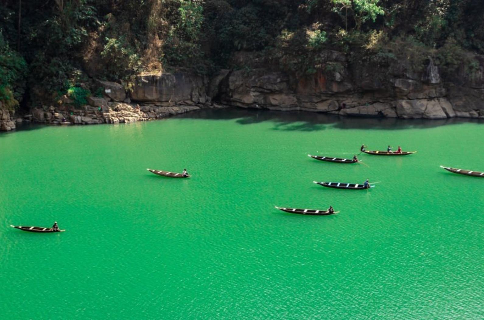 The view of boatsmen riding on their boats in Dawki river in Meghalaya, INDIA.