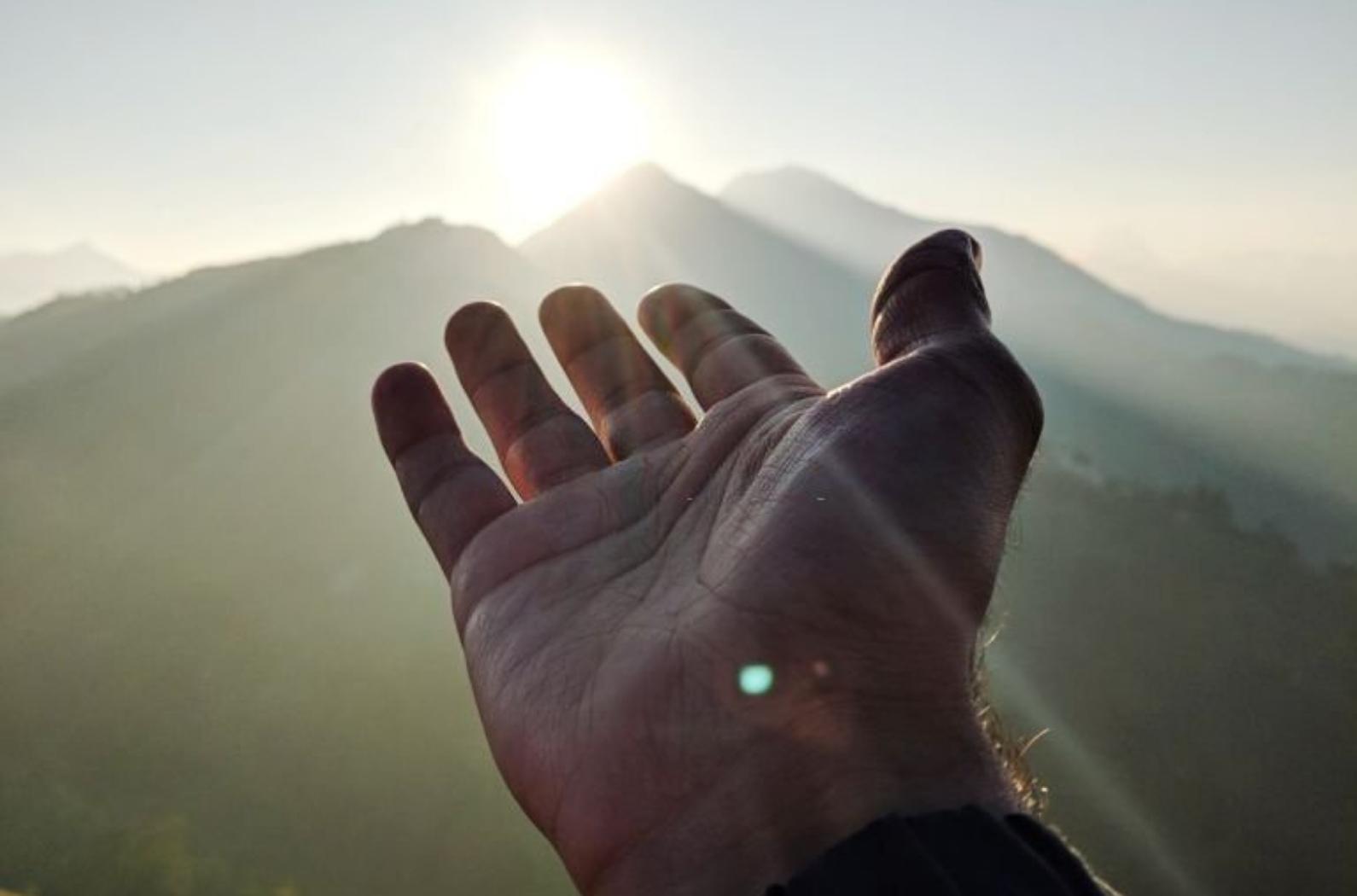 Cropped Hand Of Man Gesturing Towards Mountain Against Sky During Sunrise in Pothamedu viewpoint.