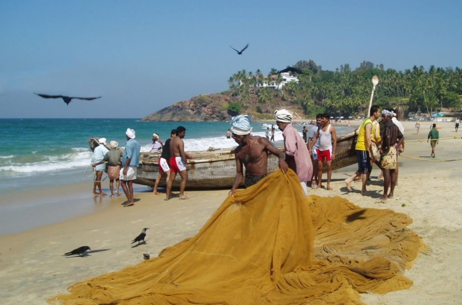 Fishermen mending Nets in Kovalam Beach.