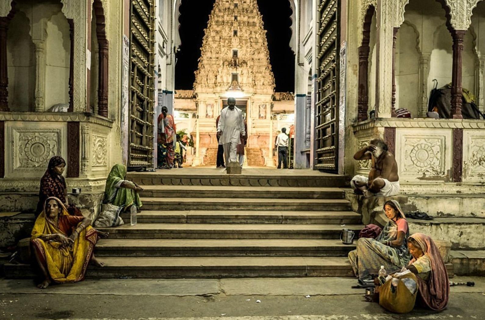 Group of beggars in front of the new Rangji temple Pushkar with its characteristic south indian architecture style is one in the more than 400 temples that exists in the holy city for hindus of Pushkar.