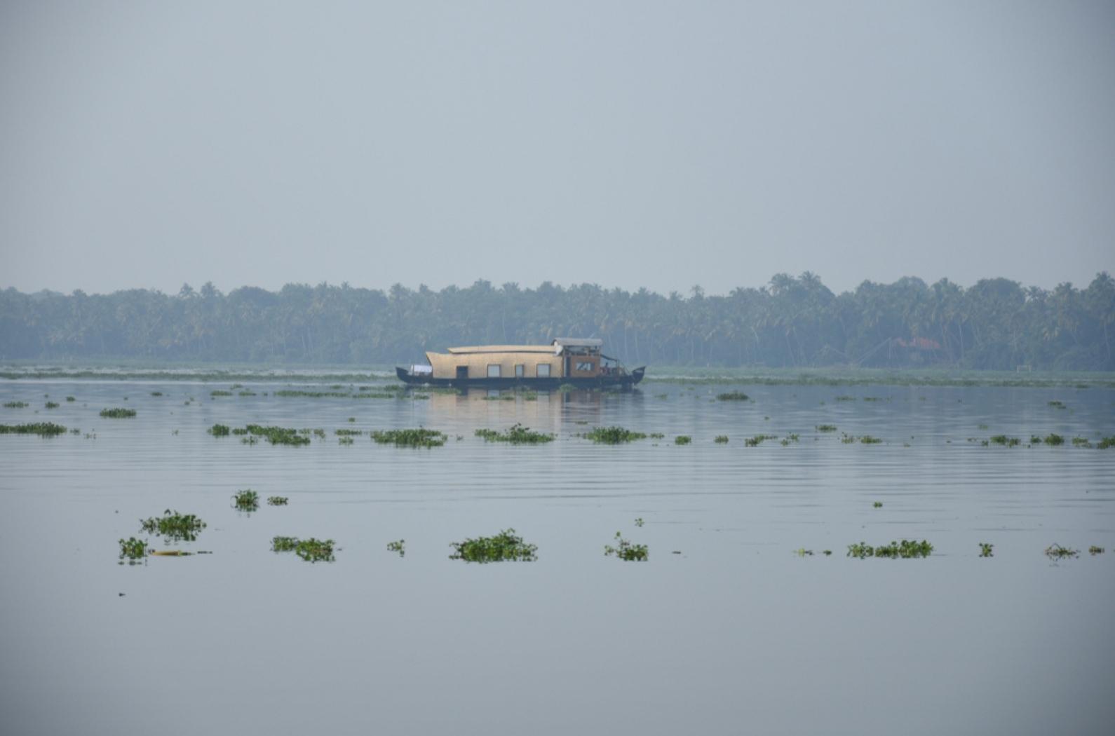 House boat riding with tourists in Vembanad lake, view from Thanneermukkom Bund.