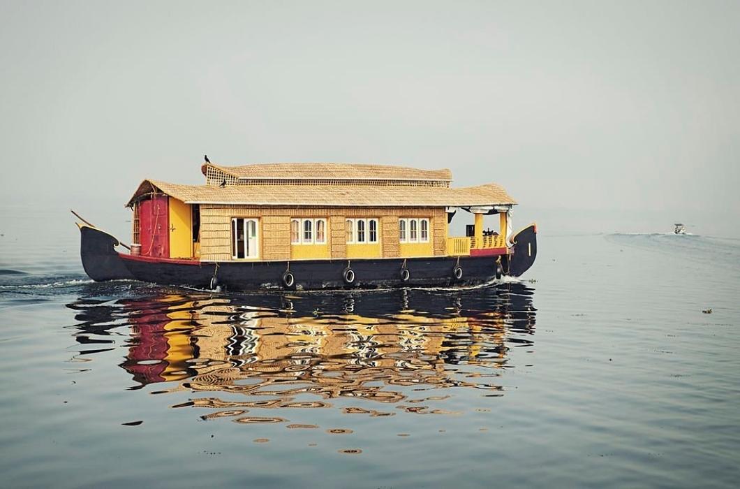 Houseboat sailing on the calm waters of Vembanad Lake in Kerala.