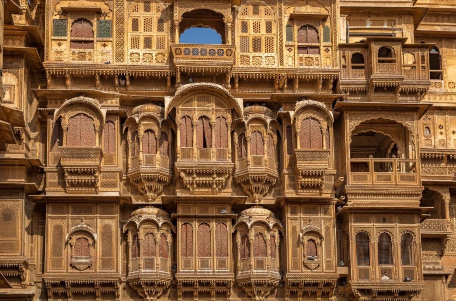 Rajasthan heritage building exterior with intricate stone artwork known as the Patwon ki haveli at Jaisalmer. A popular tourist destination.