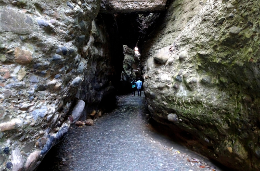 Robber's cave , Guchu Pani or gucchi pani near Dehradun Uttarakhand , a famous tourist spot with rock walls flowing water.