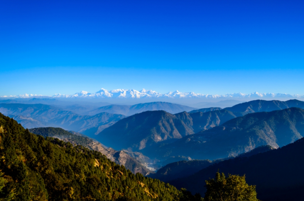 The nippy landscape of Northern India shimmers with the glow of snow clad Himalayas seen in a crisp morning from Nainital's Himalaya Darshan