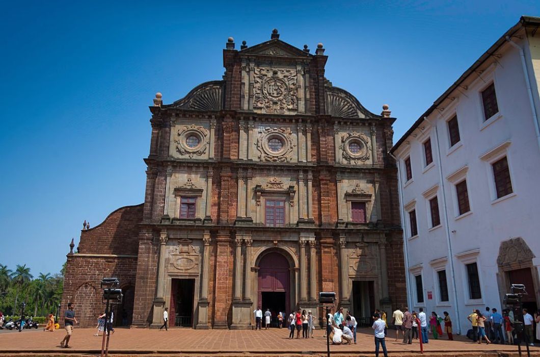 Tourists in front of The Basilica of Bom Jesus, a famous landmark located in Old Goa.