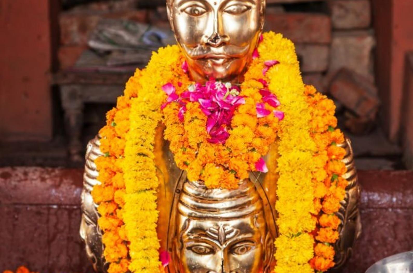 A Statue of golden color with flowers