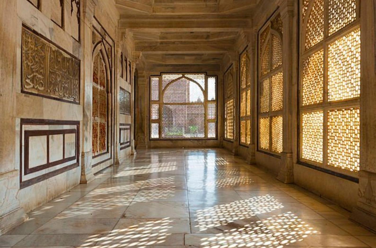 A hallway with beautiful intricate lattice windows in the central white marble tomb of Salim Chishti in the main courtyard at Fatehpur Sikri in Agra, India
