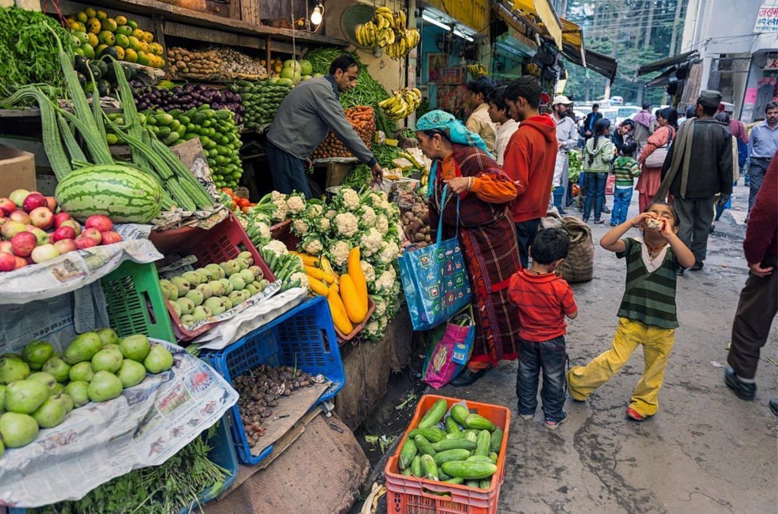 Indian woman in traditional clothes buying vegetable from man almost hidden by the products.
