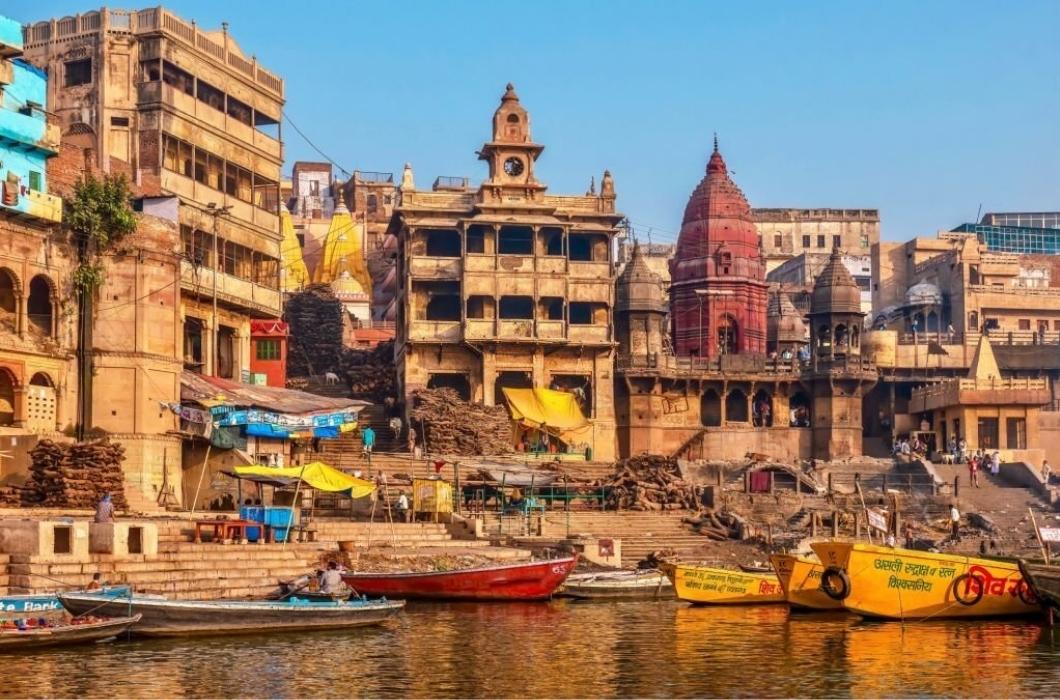 Manikarnika Ghat, the largest crematorium in the city, where stacks of wood are used for outdoor Hindu funeral pyres beside the Ganges River.