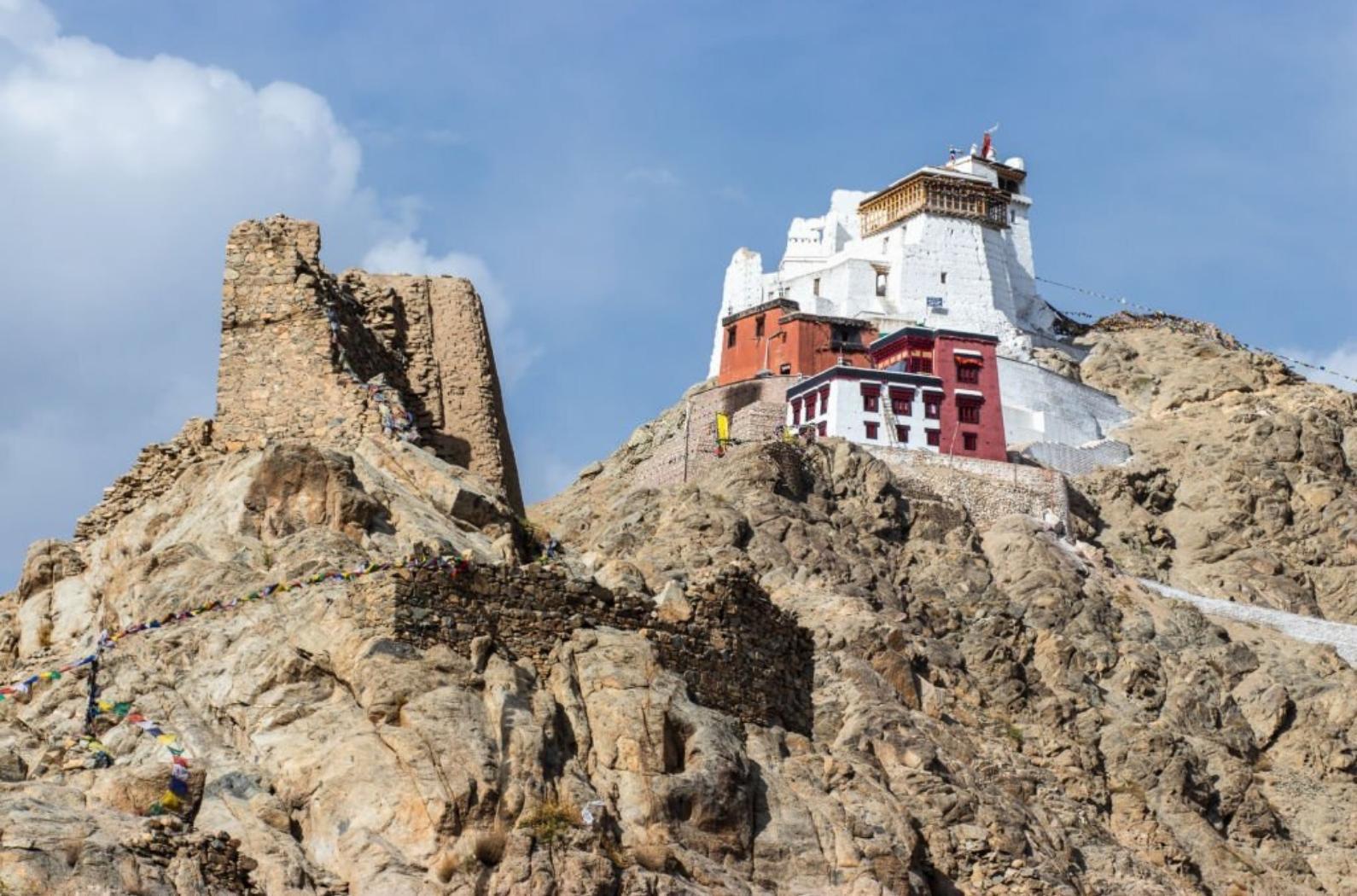 Namgyal Tsemo Gompa on the cliff with blue sky.