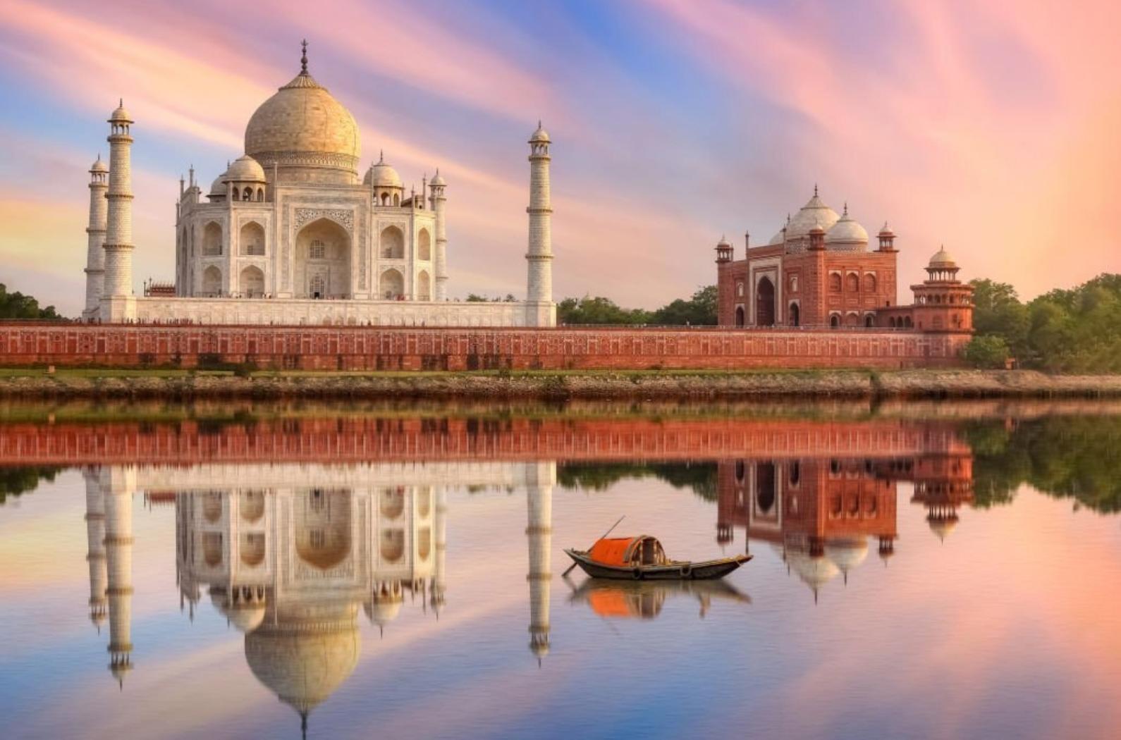 Taj Mahal Agra on the banks of river Yamuna at sunset as seen from Mehtab Bagh. Taj Mahal is a white marble mausoleum built by Mughal Emperor Shah Jahan at Agra.