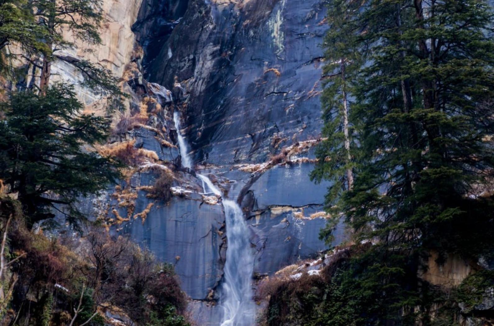 This picturesque waterfall in a remote, tranquil setting has shrines below it & is sacred to locals.