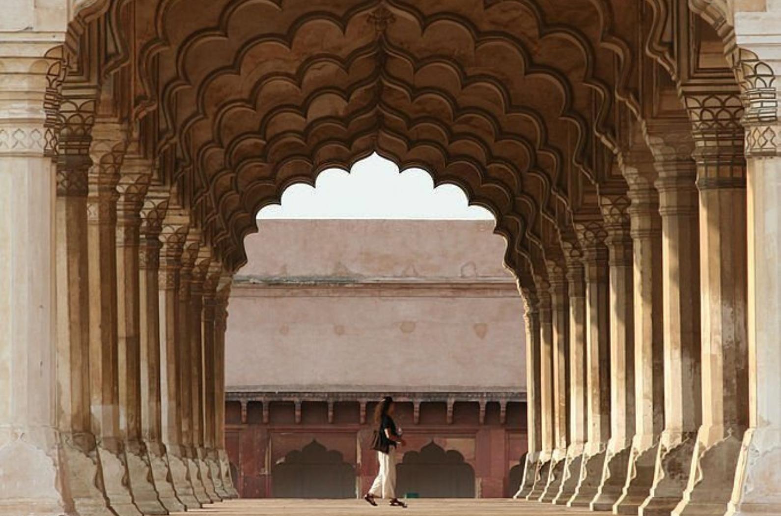 Tourist sightseeing inside the arches of Agra Fort