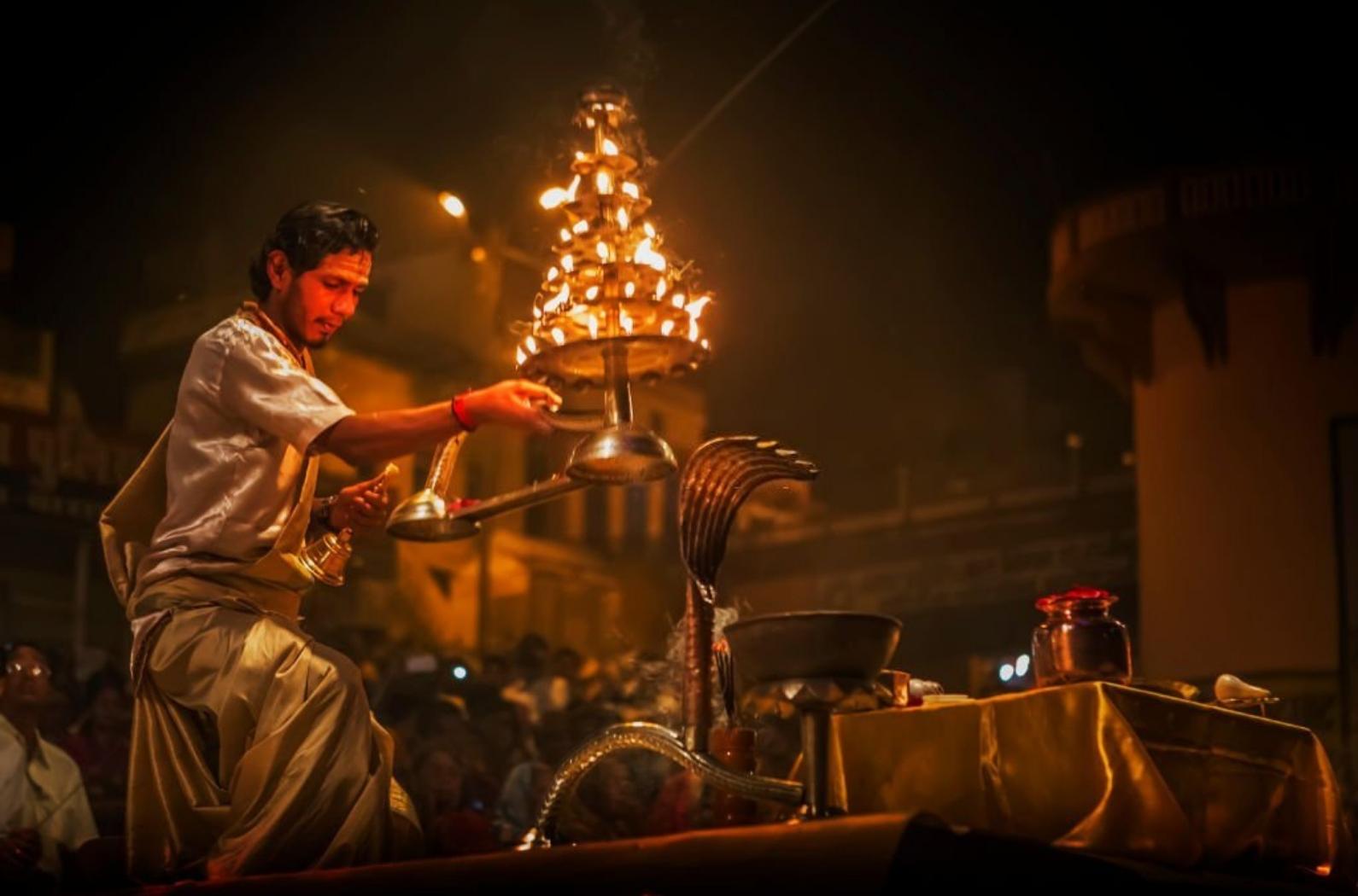 Unknown priest performing ganga aarti in banaras on the banks of ganga in Dashashwamedh Ghat